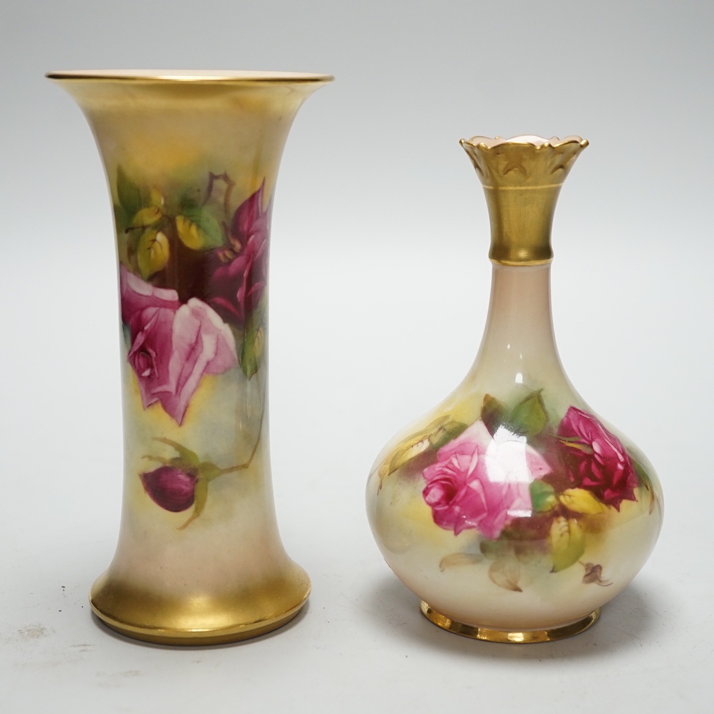 A Royal Worcester trumpet vase, shape G923 painted with roses by M. Hunt, signed, date code 1925 and another vase, shape G702 painted with roses, date code 1924, tallest 16cm